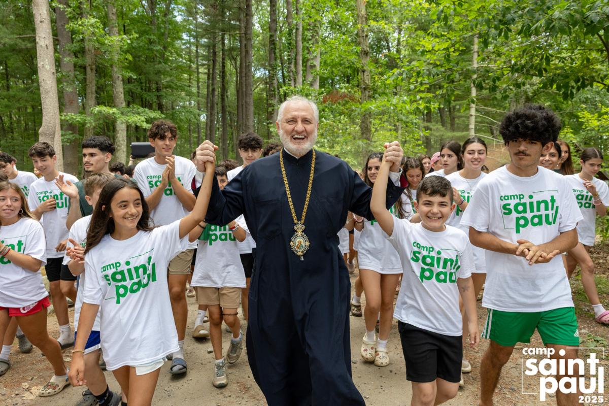 His Eminence Archbishop Elpidophoros surrounded by joyful campers at Camp Saint Paul 2025